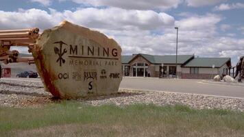 USA, UTAH - May 03, 2018 - Mining Memorial Park, Thomas Moran Park, Monument to miners and mining machines near the visit of the center video