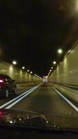 A car travels through a road tunnel built into a mountain in the USA. video