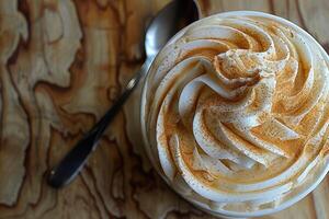 A Delicious and Creamy Whipped Cream Topped Dessert Beautifully Displayed on a Wooden Table photo