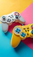 Colorful Game Controllers on Vibrant Background. Two game controllers, one white and one yellow photo