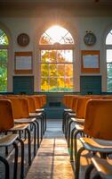 A classroom with many empty chairs and a clock on the wall. The room is empty and the sun is shining through the windows photo