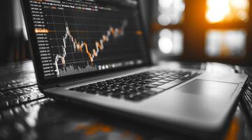 A laptop computer displaying a graph of stock prices photo