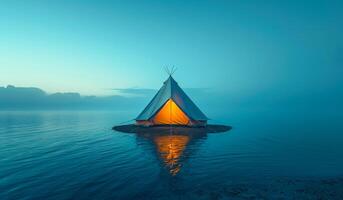 A small teepee is floating on the water. The teepee is lit up with a light inside photo
