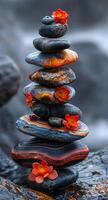 A stack of rocks with a flower on top photo