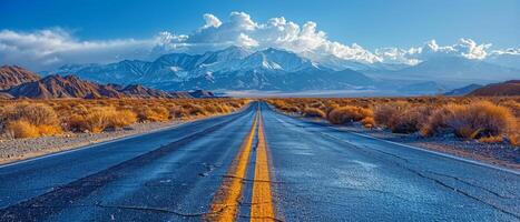 A road with a yellow line down the middle. The road is empty and the sky is blue photo