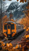 A blue and white train is smoothly going down the tracks swiftly photo