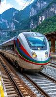 A blue and white train is smoothly going down the tracks swiftly photo
