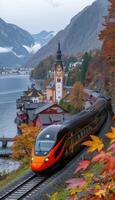 An orange and black train is steadily making its way down the tracks photo
