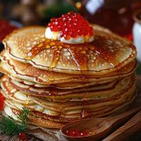 fried pancakes with red caviar photo