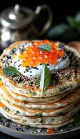 fried pancakes with red caviar photo