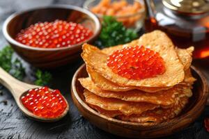 fried pancakes with red caviar photo