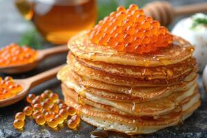 fried pancakes with red caviar photo