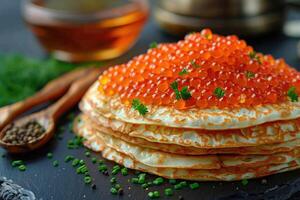 fried pancakes with red caviar photo