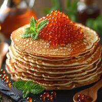 fried pancakes with red caviar photo