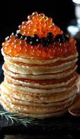 fried pancakes with red caviar photo