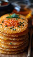 fried pancakes with red caviar photo
