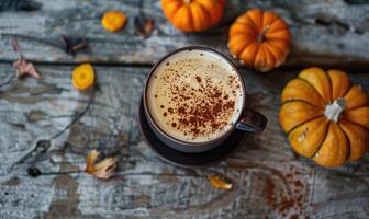 A cappuccino with pumpkin slices and small pumpkins photo
