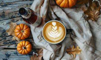 A latte art coffee with pumpkin slices and a pumpkin in the background photo