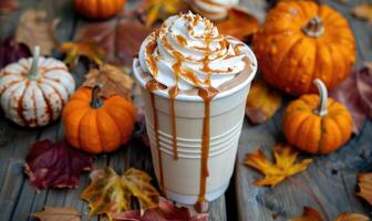 A pumpkin spice latte with a drizzle of caramel photo