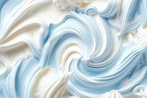 Blue and white whipped cream swirl texture, close-up. photo