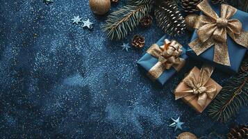 Christmas and New Year background. Gifts, fir branches, pine cones on blue background. Top view with copy space. photo