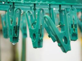 Close-up of clothespin with raindrops on it photo
