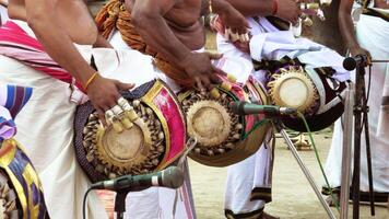 An artists playing Maddalam, a South Indian traditional musical instrument photo