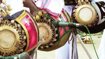 An artists playing Maddalam, a South Indian traditional musical instrument photo