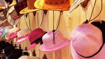 Colorful hats displayed in a street shop photo