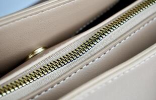 Close up part on hand bag zipper and round magnet lock snap parts. Object detail photography isolated on horizontal background. photo