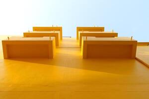 Row balcony of bright yellow beside building and clear sky in look up view in Thailand. photo