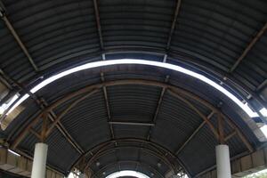 Under old metal curve roof in vintage and simplicity style cover walkway in Thailand. photo