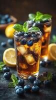 Refreshing iced tea with blueberry and lemon on a rustic table photo