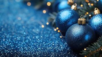 Christmas baubles and pine cones creating festive atmosphere on blue glitter photo