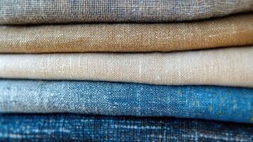 Stack of linen fabric in various colors showing texture photo