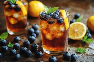 Refreshing iced tea with blueberry and lemon on a rustic table photo