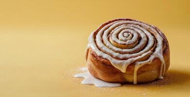 Cinnamon roll with sugar on yellow background. Selective focus. photo