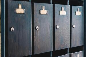Old wooden mailboxes with empty name tags photo