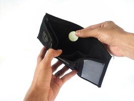 A man's hand takes and shows money from a wallet isolated on white background, rupiah is the currency of Indonesia photo