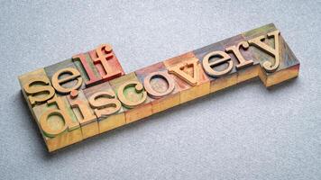 self discovery text in letterpress wood type, exploring, learning, setting goals and personal development concept photo