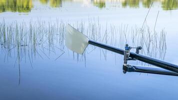 hatchet sculling oar on a calm lake, Boyd Lake in Colorado photo