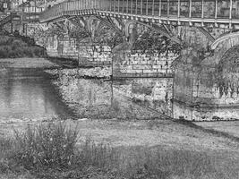 Old stone bridge in Ireland, ancient bridge made of stones and b photo