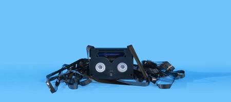 Old damaged black mini DV cassette with the tape outside surrounding the cassette photo