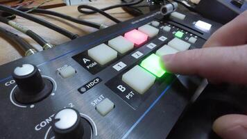 Director's hand in TV studio that controls mixer. Switch cameras during broadcast. video
