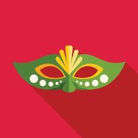 Green and yellow carnival mask is lying on red background vector