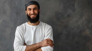 Smiling Muslim Man with Beard and Crossed Arms Pose photo