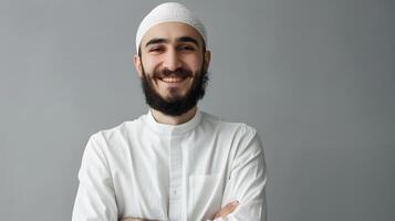Smiling Muslim Man with Beard and Crossed Arms Pose photo