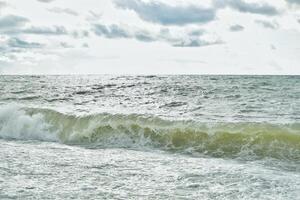 Big waves in the sea. Beautiful sea with splashes under the bright morning sunlight. photo