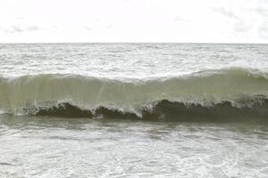 Big waves in the sea. Beautiful sea with splashes under the bright morning sunlight. photo