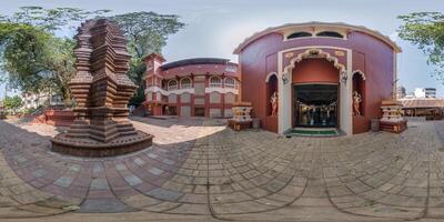 full hdri 360 panorama near hindu temple of goddess laxmi with gopuram tower in jungle among palm trees in Indian tropic town in equirectangular projection. VR AR content photo